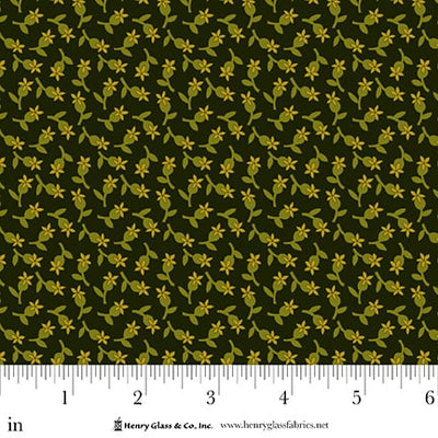 Fabric with small yellow floral pattern on a green background, featuring a ruler at the bottom.