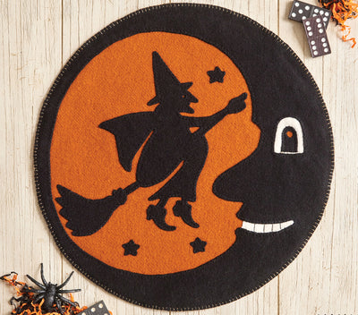 Halloween-themed mat with witch design on an orange background
