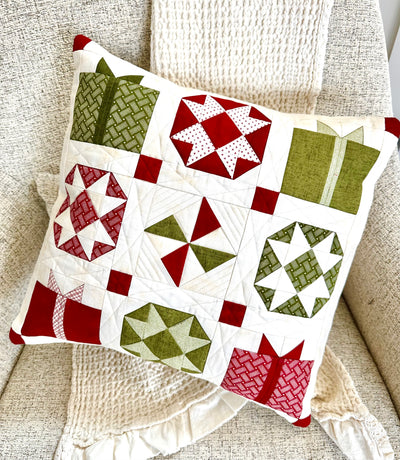 Christmas pillow with pieced present, bulbs and more.