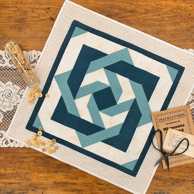 Quilt with geometric pattern on a wooden surface